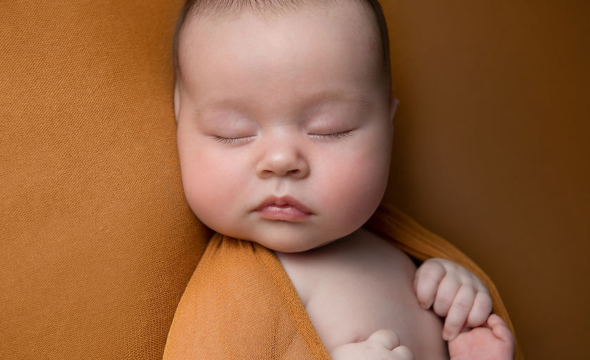 Newborn baby girl asleep during photoshoot