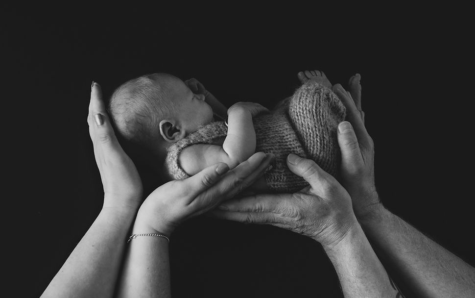 Baby photo in parents hands black and white by belfast photographer Northern Ireland