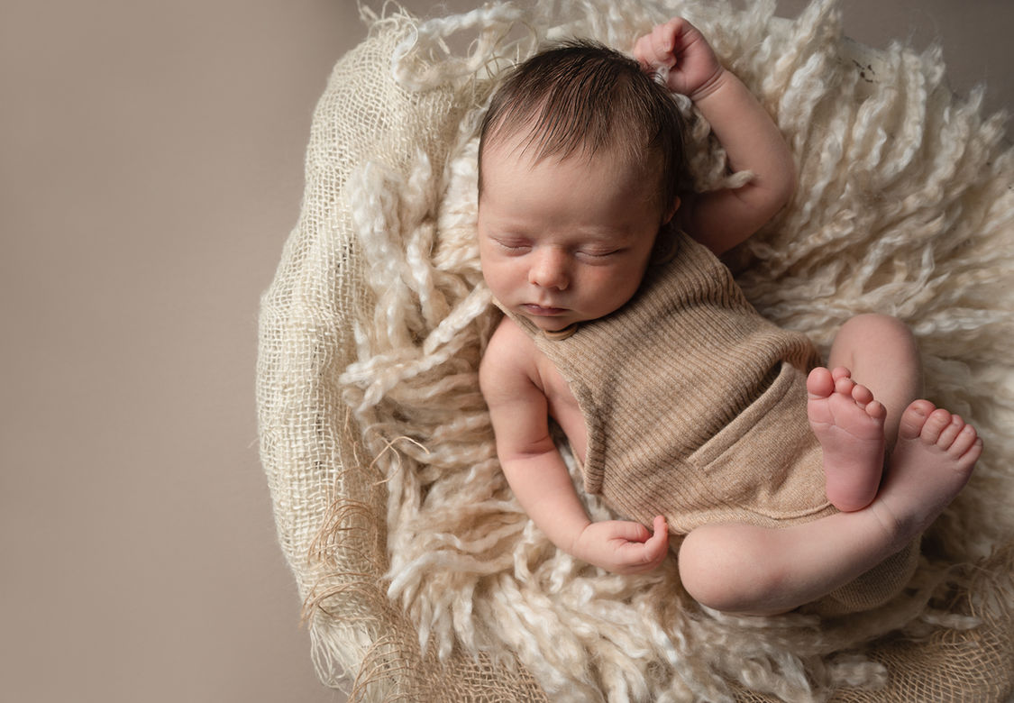 lisburn baby photoshooot of relaxed newborn boy on neutral colours